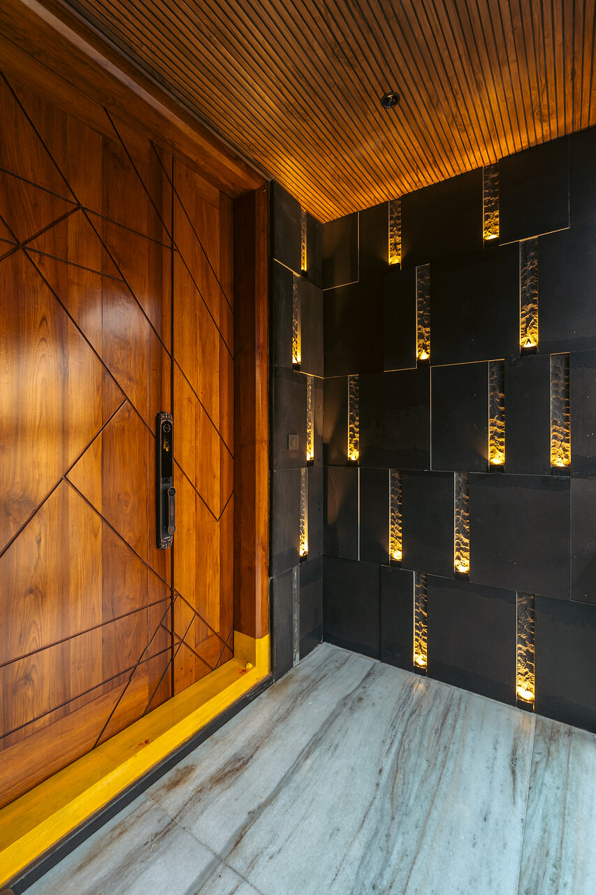 Brass pendants drop the length of the corridor.