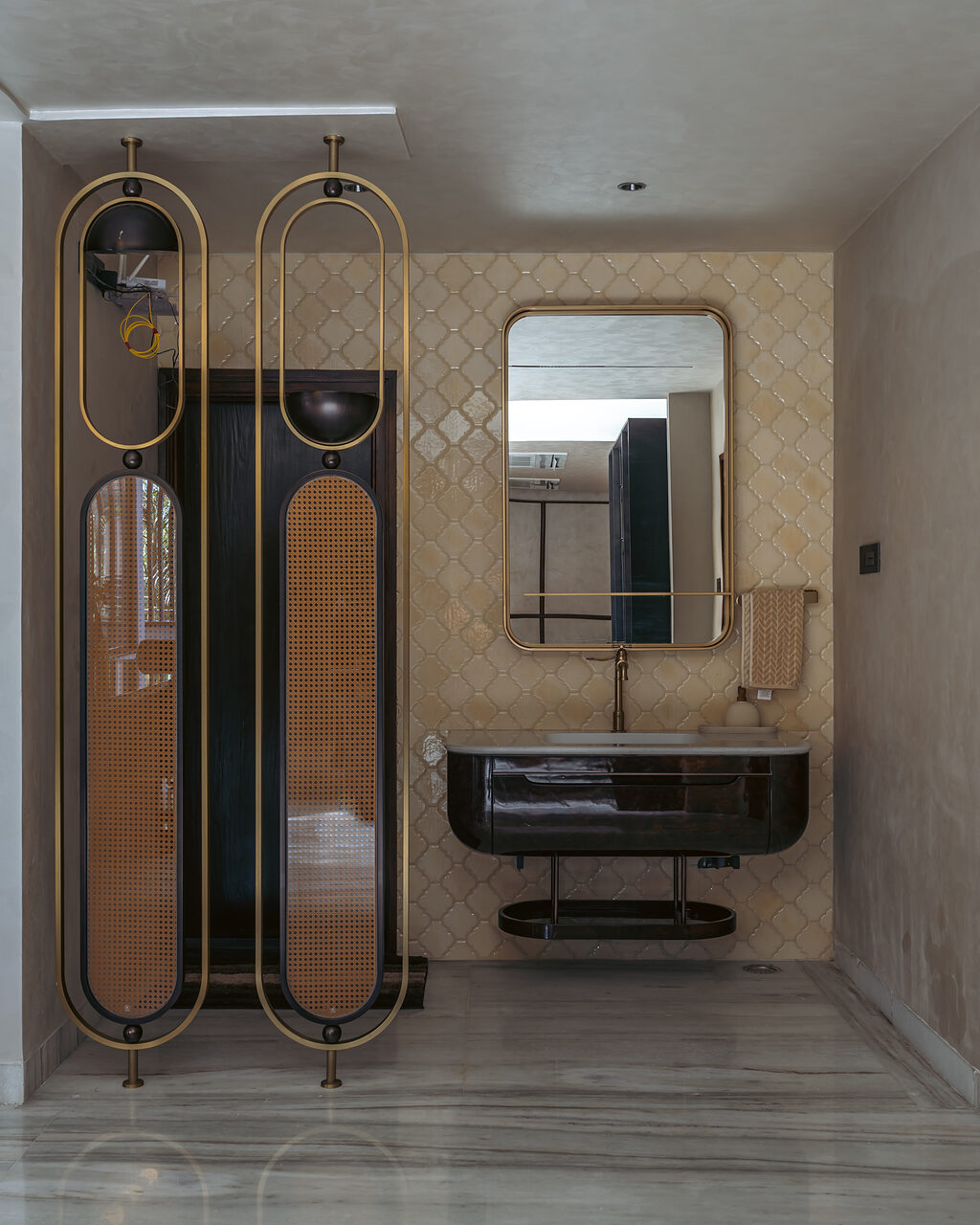 The foyer console under a brass oval mirror.