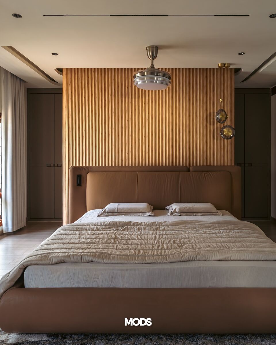 A walnut-slatted headboard wall.